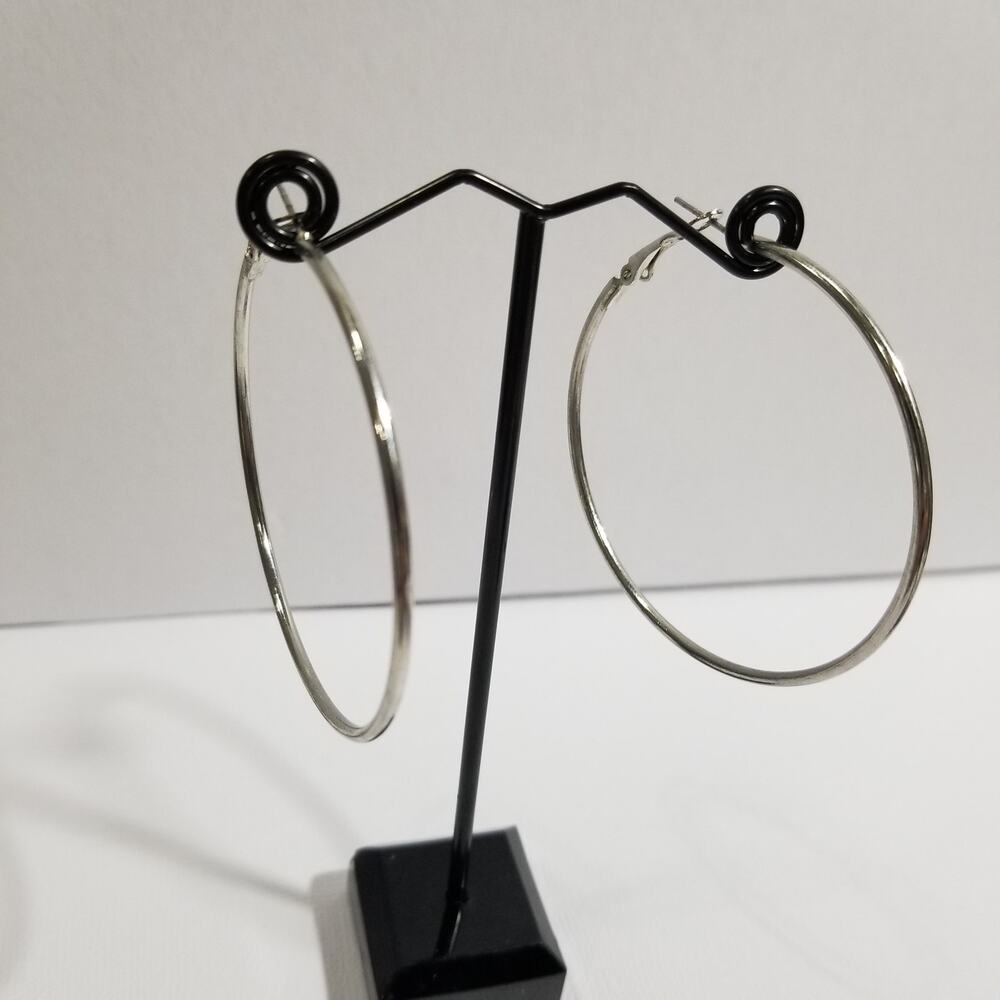 Silver tone hoop earrings pierce two inches